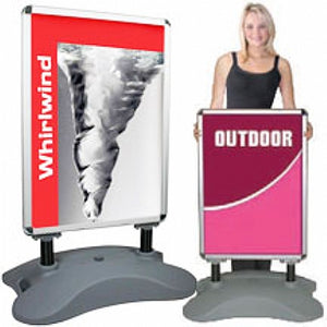 woman standing behind an outdoor water base snap frame display